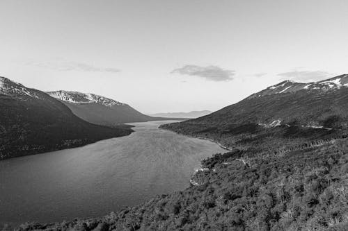 Grayscale Photo of Lake and Mountains