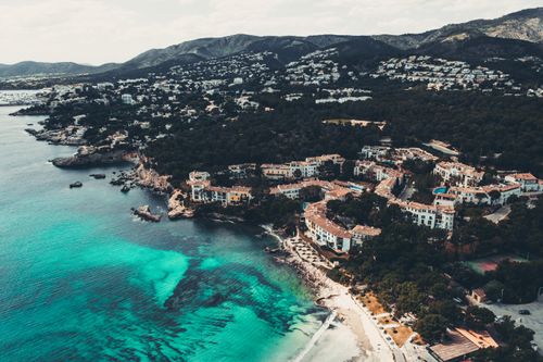 Free Experience the breathtaking aerial view of Palma, Spain, with its picturesque coastline and vibrant blue waters. Stock Photo