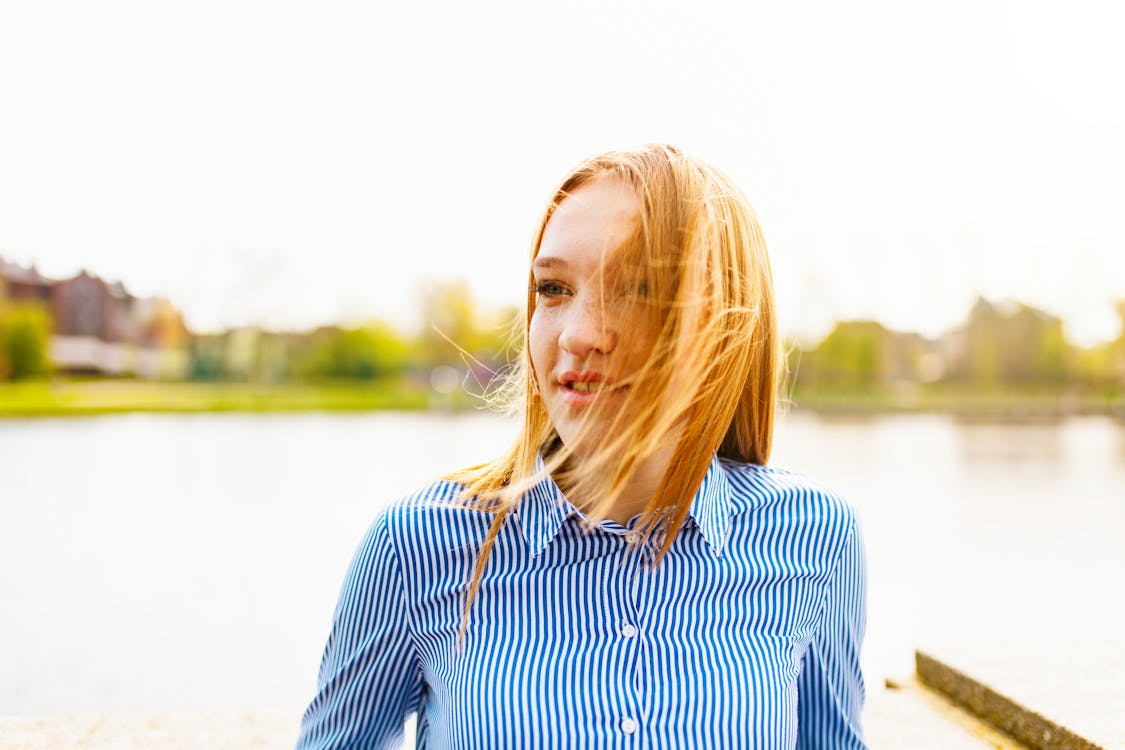 Woman Posing While Behind Body of Water