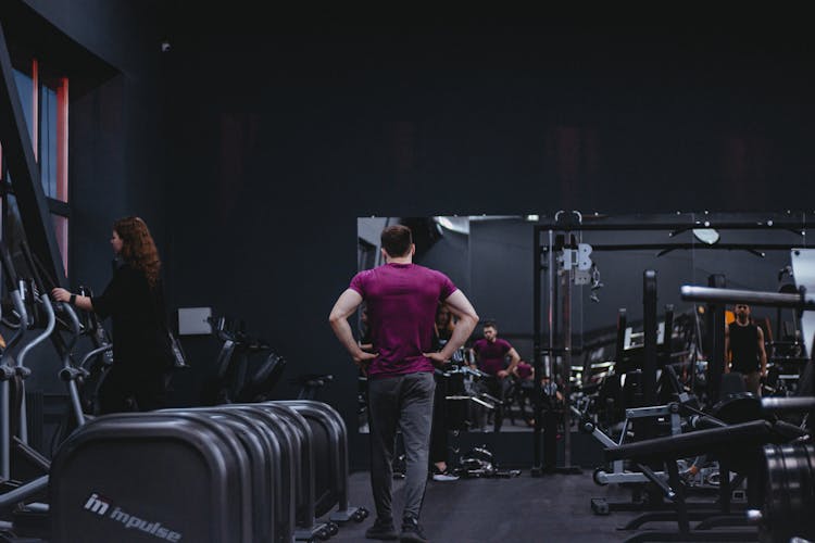 A Man In Purple Shirt Walking In The Gym