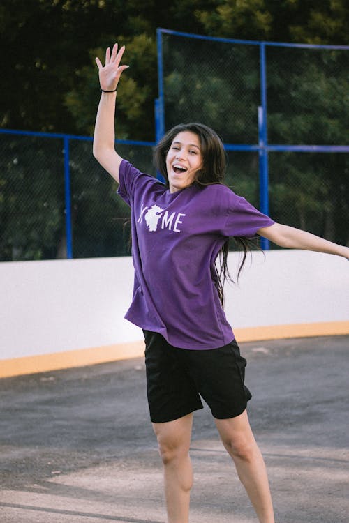Woman in a Purple Shirt Jumping