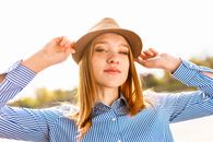 Woman Wearing Brown Hat and Blue Striped Dress Shirt
