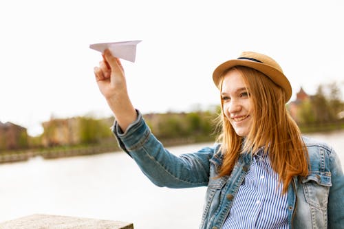 Girl Holding Paper Plane