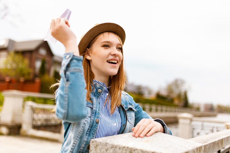 Woman Throwing Paper Airplane