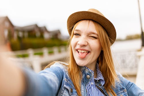 Free Selective Focus Photography of Woman Taking Photo of Herself Stock Photo