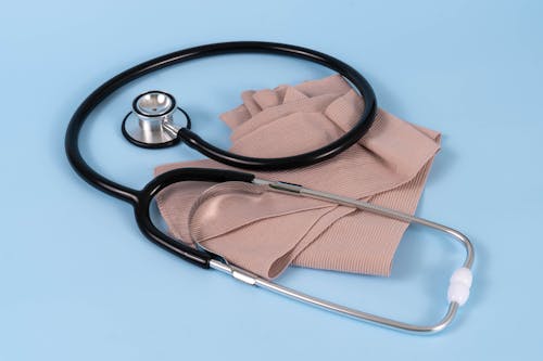 A Stethoscope and a Bandage on a Blue Surface