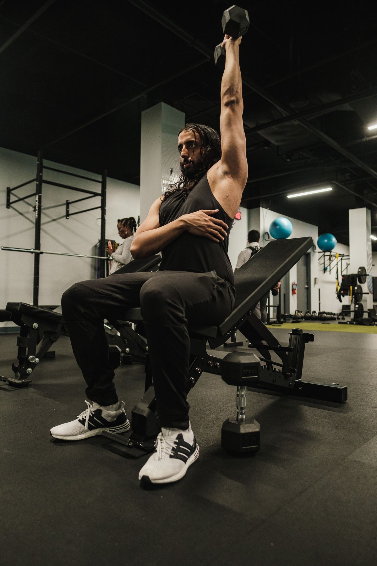 The best shoulder workout for bigger, stronger delts | the gym pro Muscular Man Performing A Dumbbell Shoulder Press In A Gym