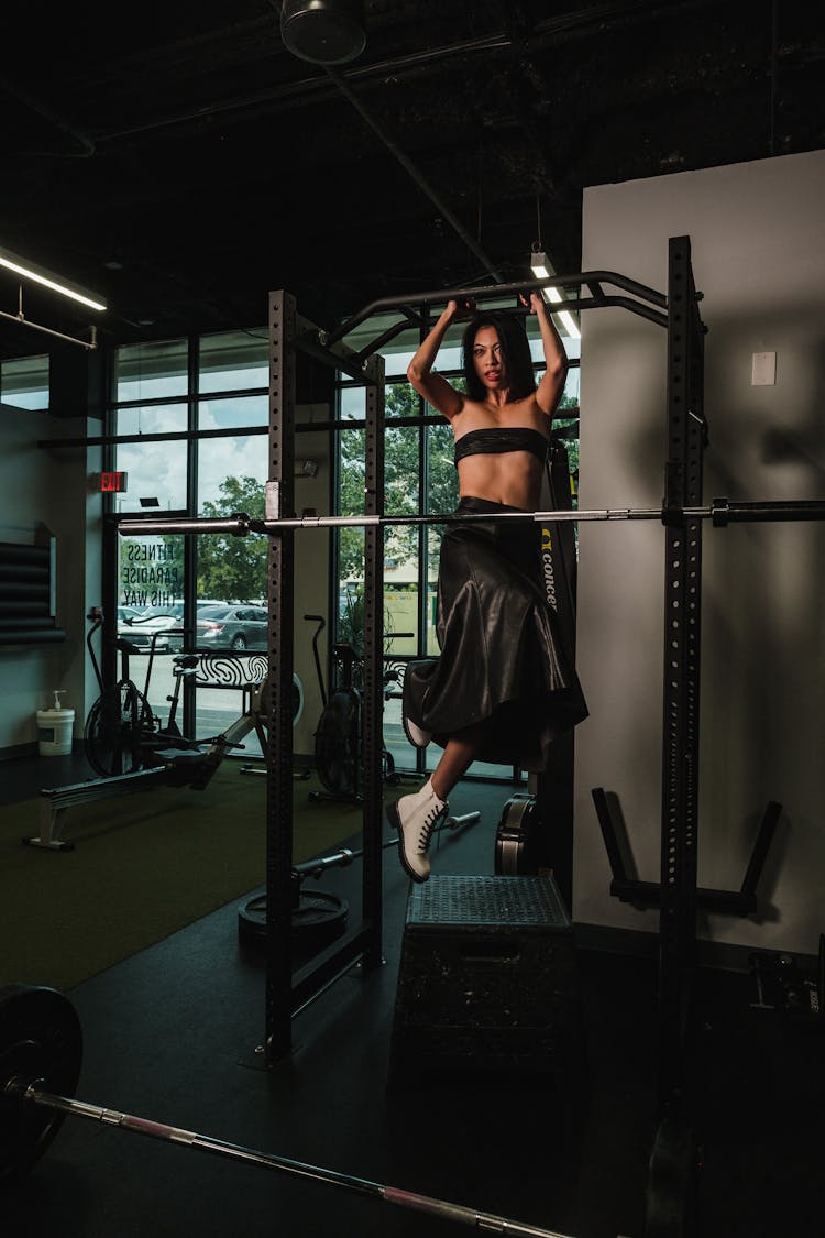 A Woman Hanging On A Pull-Up Bar