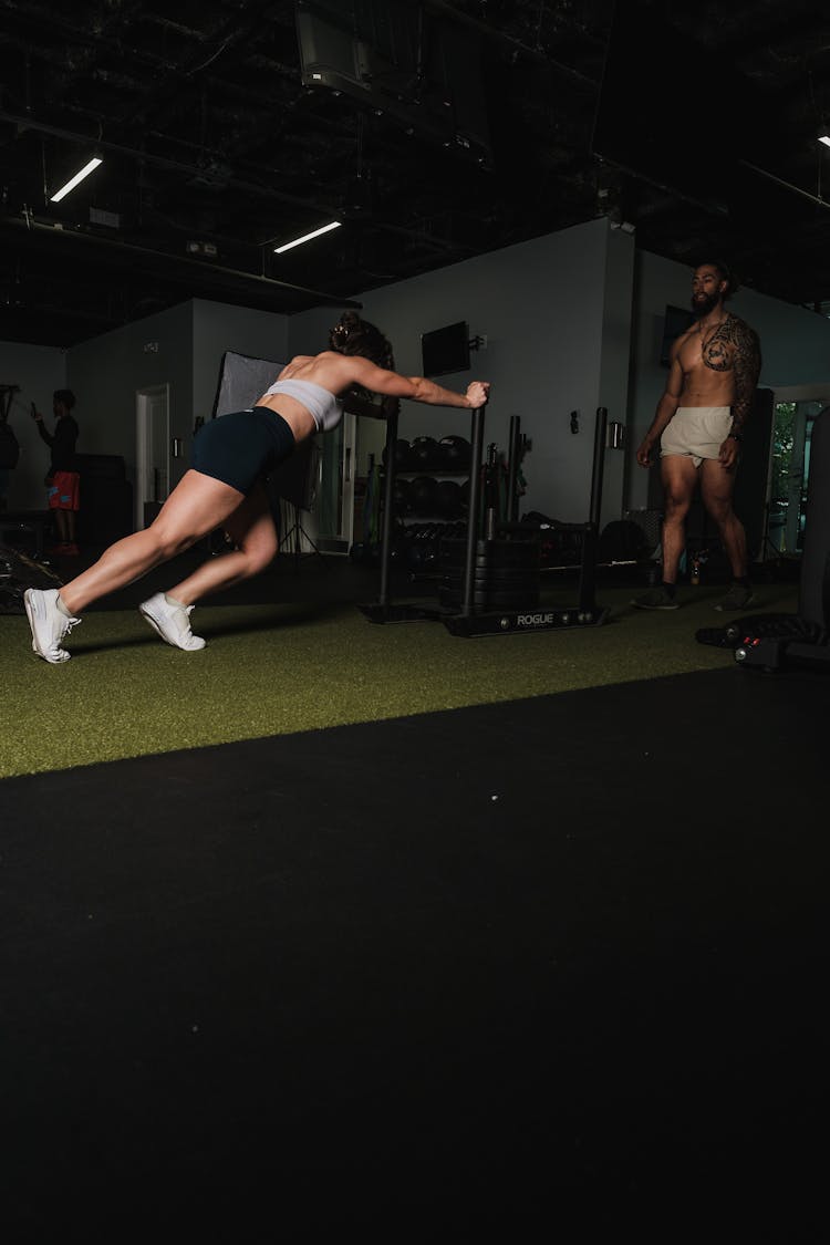 Woman Pushing A Gym Equipment