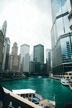 Explore the iconic architectural skyline along the Chicago River with towering skyscrapers and vibrant urban life.