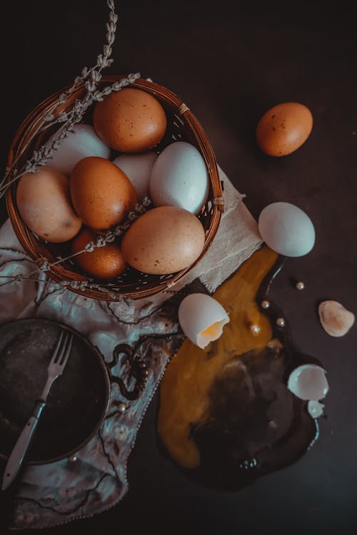 Brown and White Eggs in Woven Basket