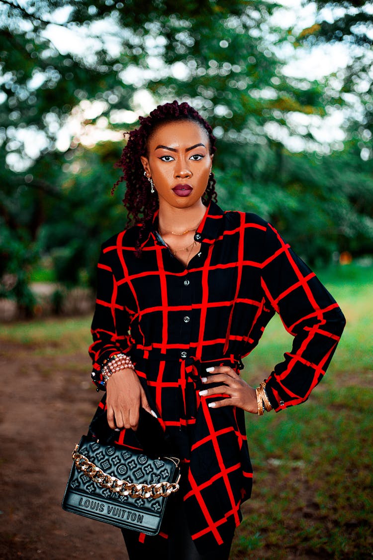 Woman With A Black Purse Posing With Her Hand On Her Waist