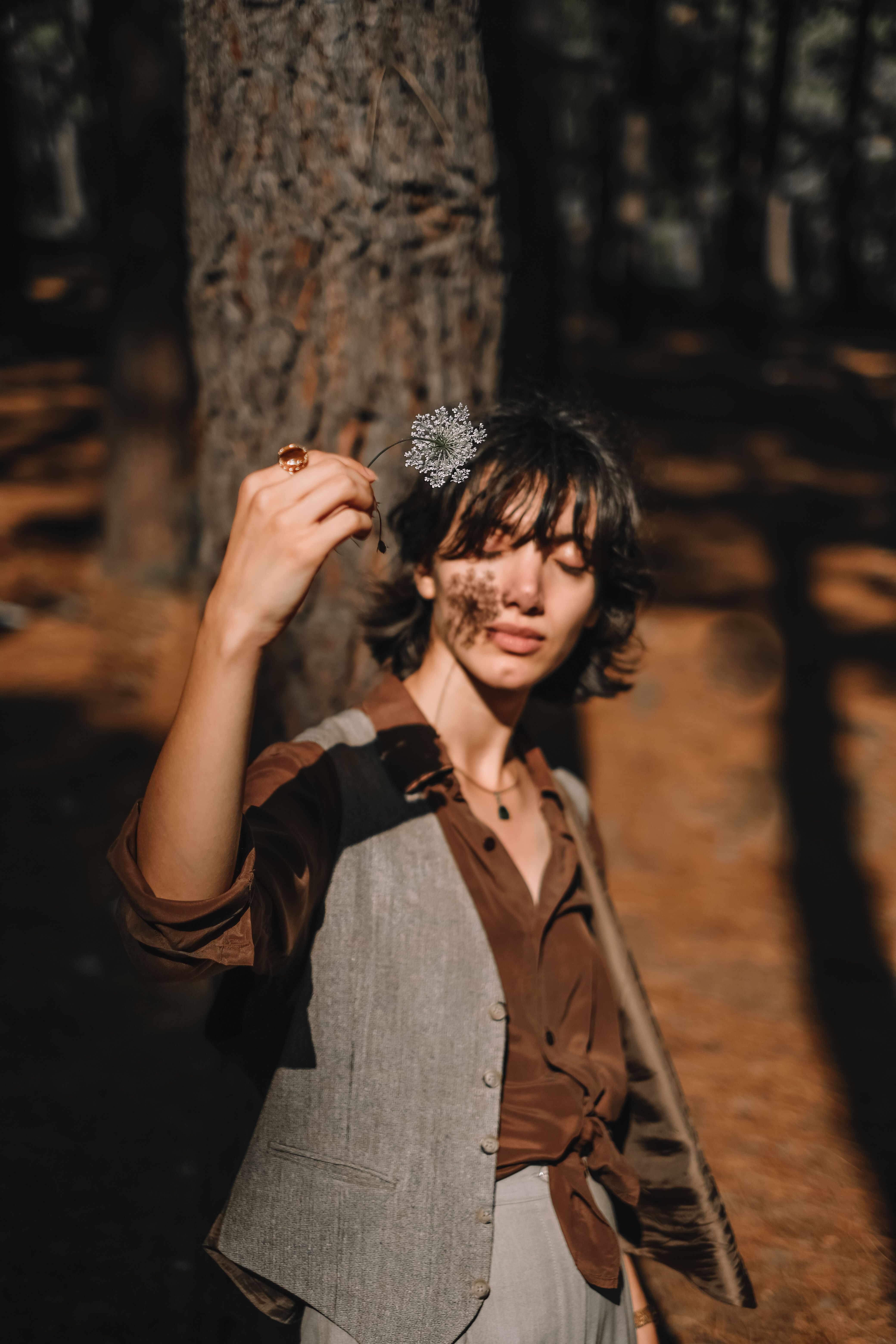 Woman Standing beside Brown Tree Trunk · Free Stock Photo