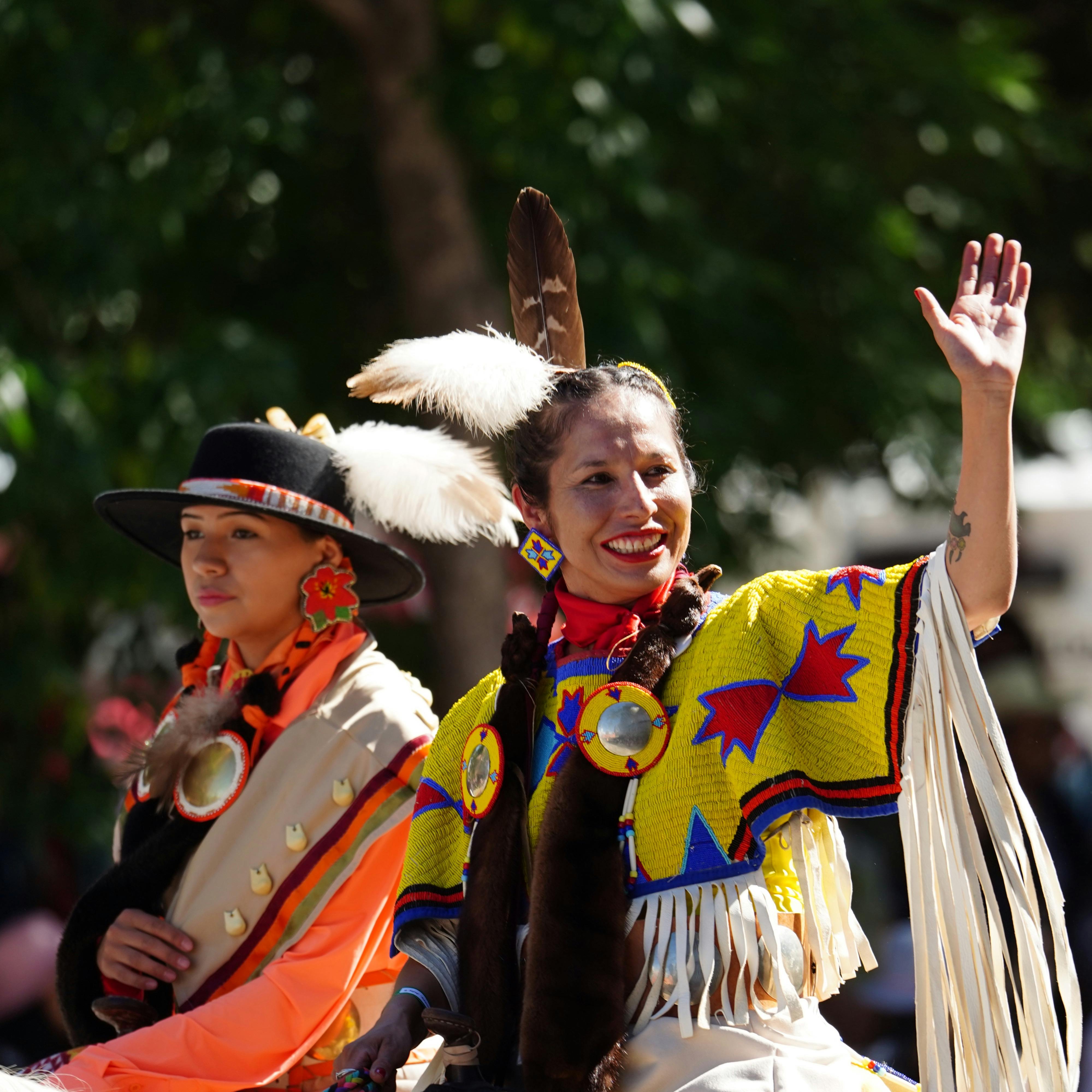 Native American women in traditional cultural dress.