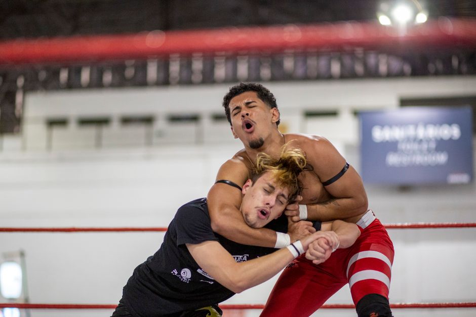 Clashes Dominate First Meeting of New Boca Raton City Council 2 Two wrestlers in a dynamic match in Anhembi, São Paulo, showcasing strength and technique. | BocaVibe