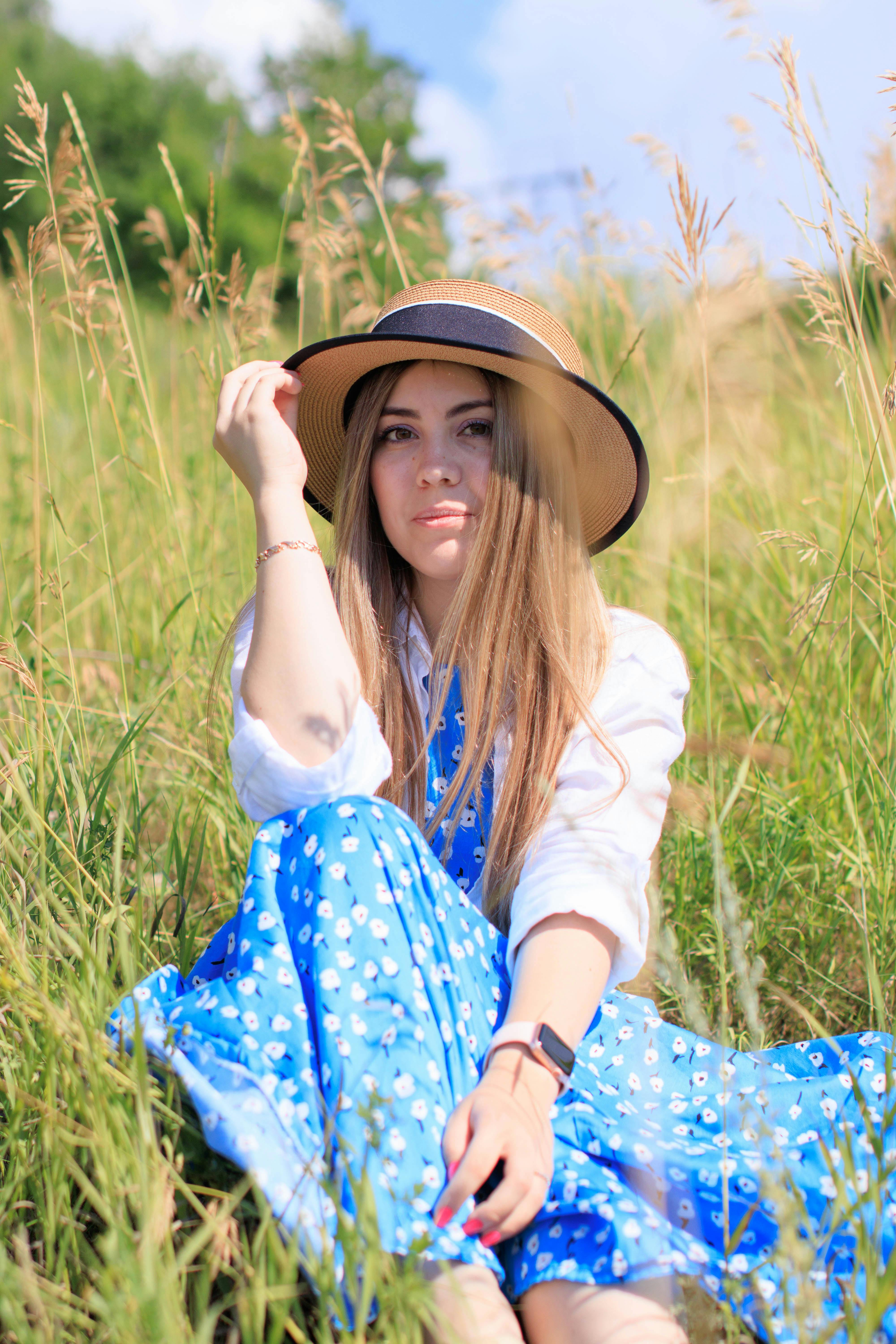 Person in Floral Dress Holding an Oval Mirror · Free Stock Photo