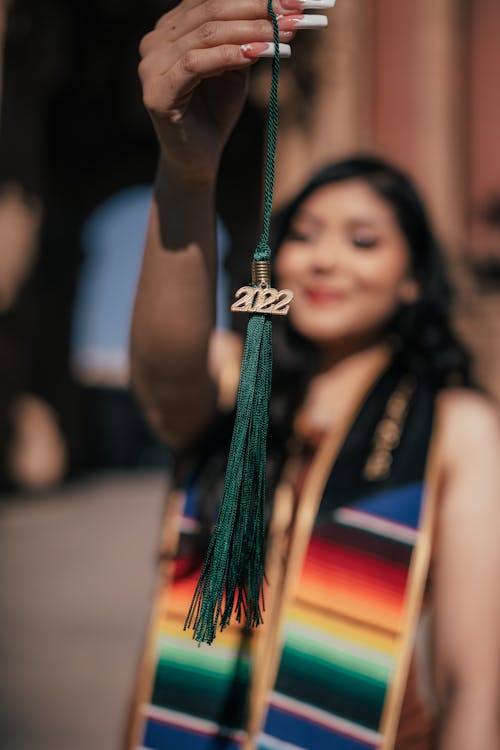 A Woman Holding a Tassel with 2022