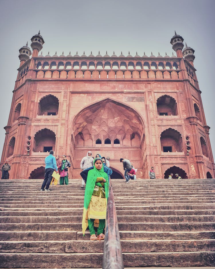 People Standing On Steps In Front Of The Masjid-i-Jehan-Numa Mosque In Dehli, India