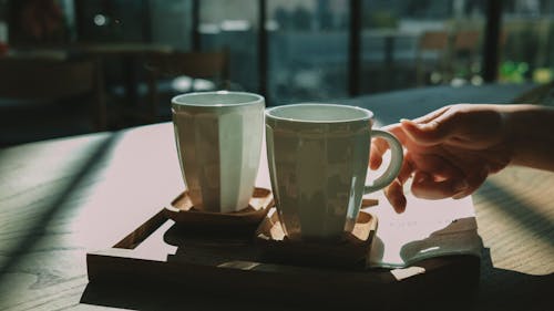 A Person's Hand Grabbing a Cup