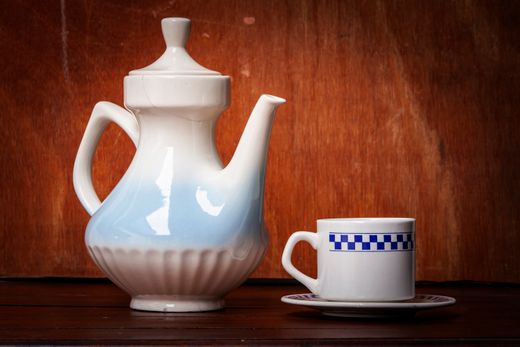 Ceramic teapot and cup on a wooden surface — photo by Arturo Añez on Pexels