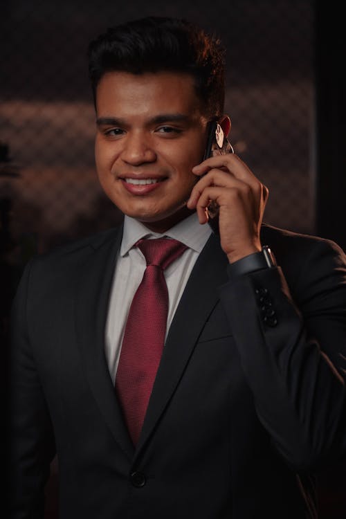 A Portrait of a Man in a Suit in a Phone Call