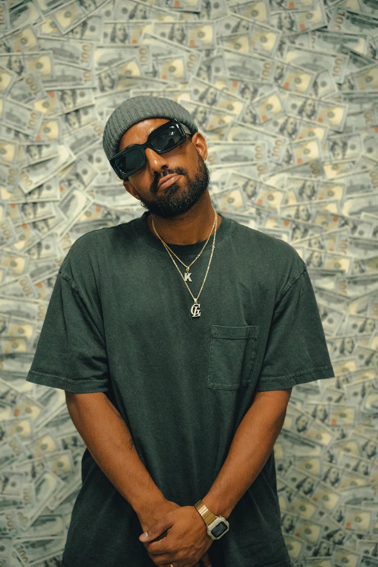 Rapper In Sunglasses On Dollar Wall Background