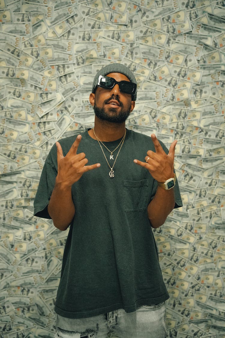 Rapper In Sunglasses Showing Hand Gesture