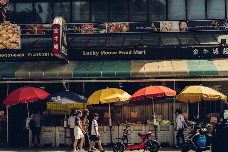 People Walking On Street Near The Market