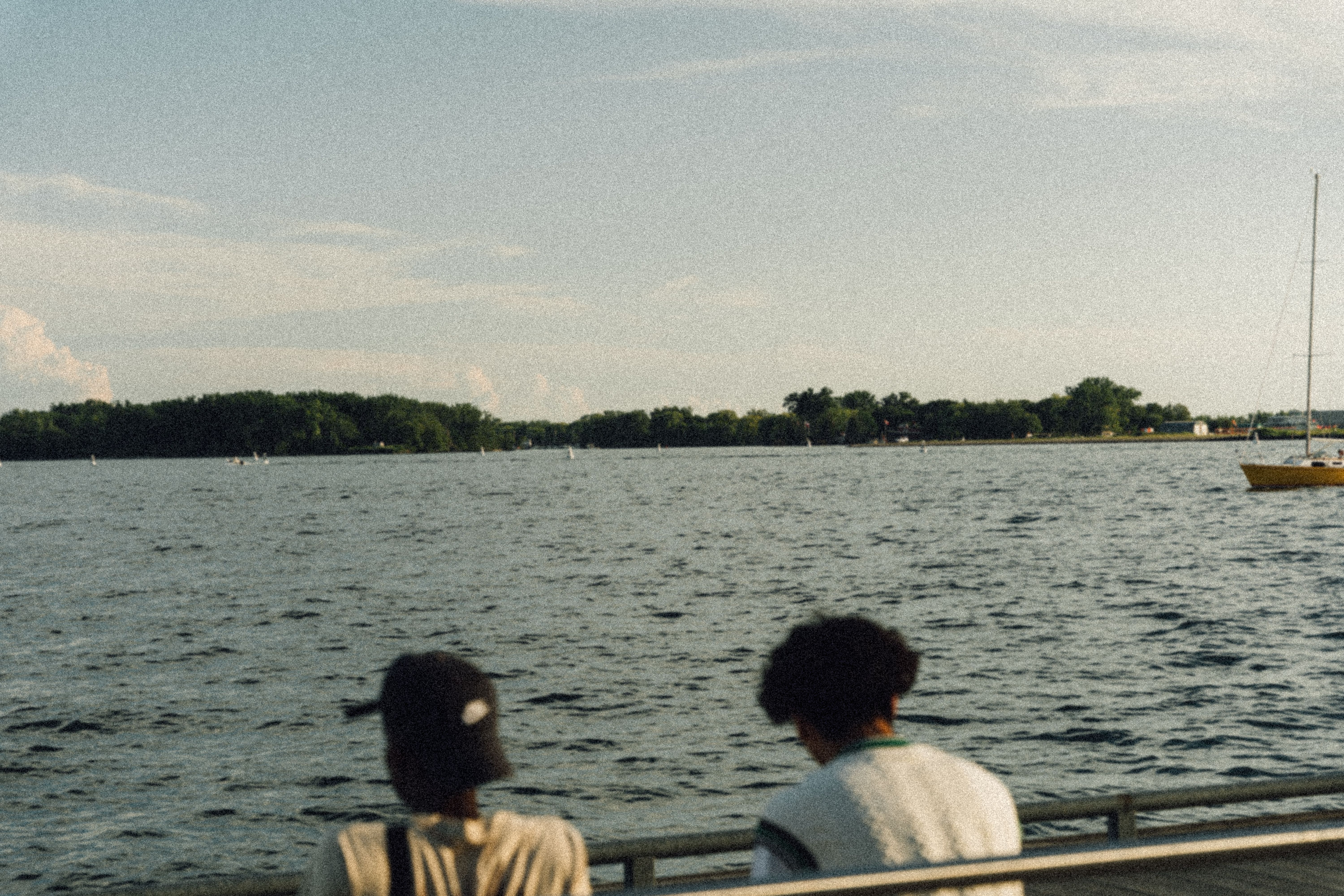 People Sitting Beside the Body of Water · Free Stock Photo
