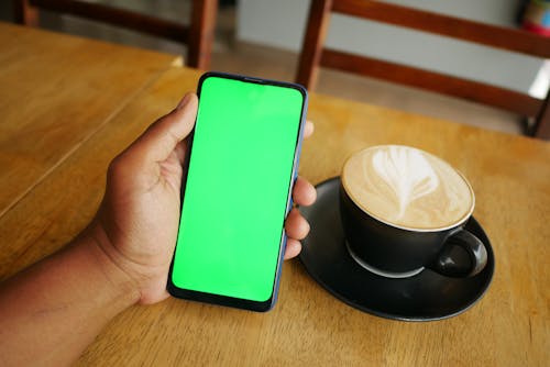 Cellphone Beside a Cup of Coffee