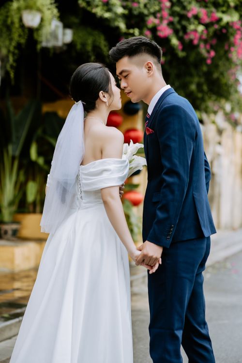Free Bride and groom kissing outdoors, capturing love and romance on their wedding day. Stock Photo