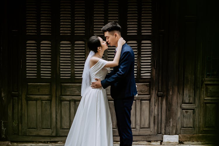 Portrait Of Newlyweds Kissing