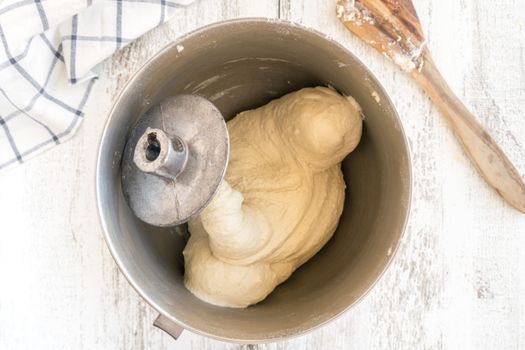 Top view of dough in a mixer bowl ready for baking preparation.