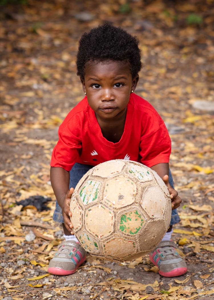 Photo Of A Kid Holding A Football