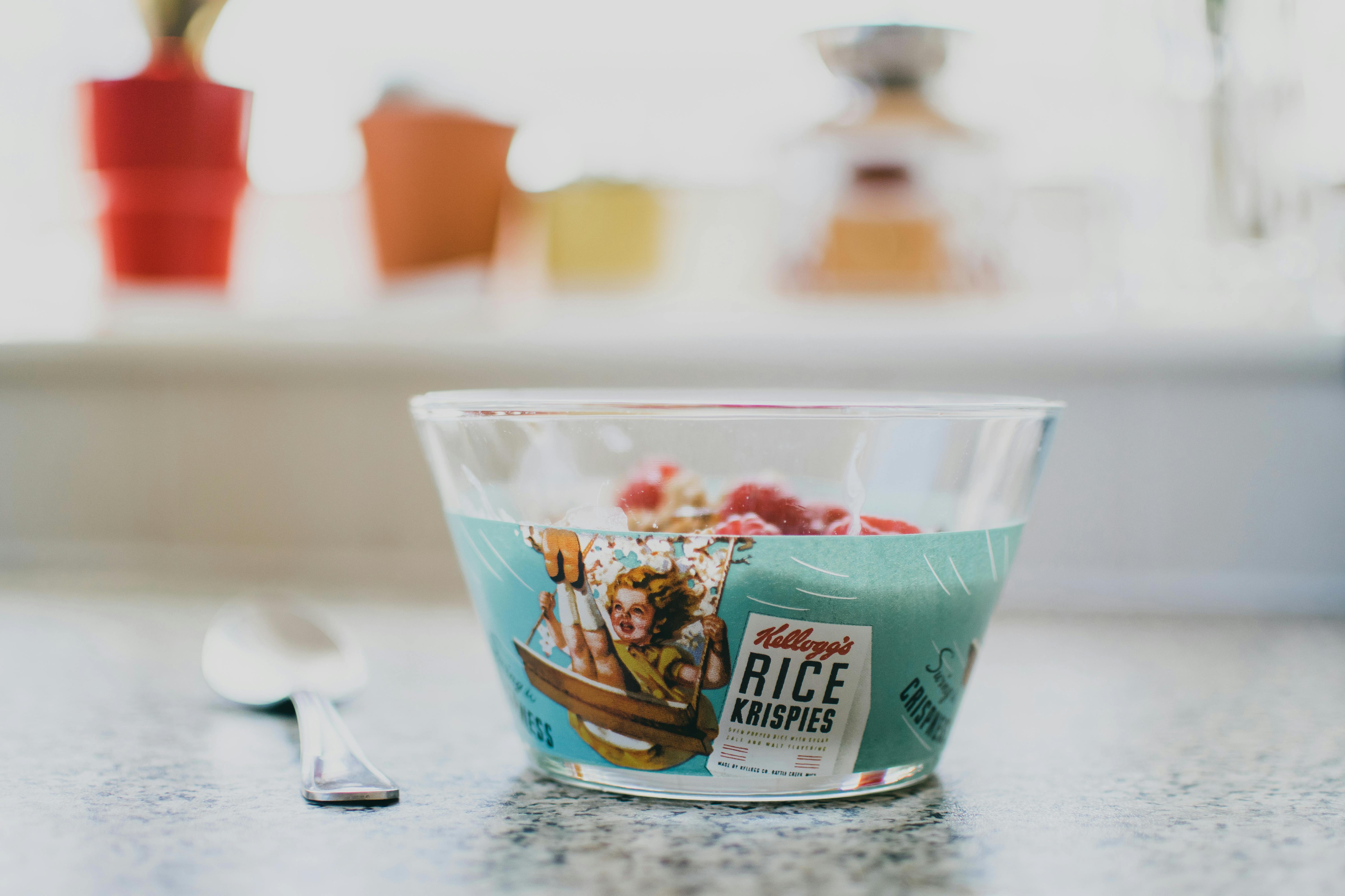 rice krispies desert cup near spoon on gray counter top