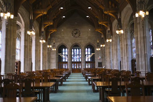 Quiet study area with wooden desks and stained glass in Boston's library.