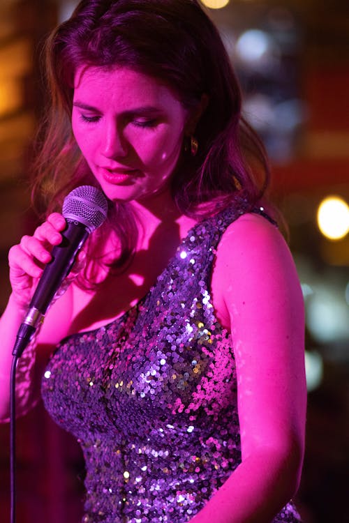 Free Woman in Purple Sequin Dress Singing Stock Photo