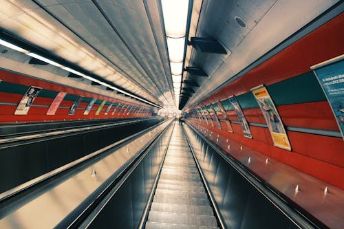 Gray Escalator Beside Posters