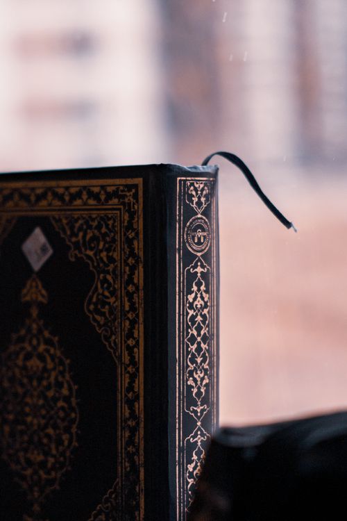 Free Vertical close-up of an ornate Quran with decorative spine, symbolizing Islamic culture. Stock Photo