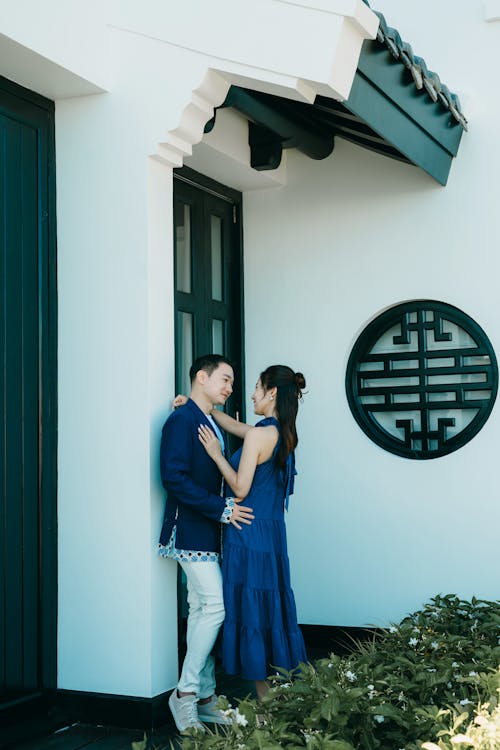 Young Couple Hugging in Front of a Building 