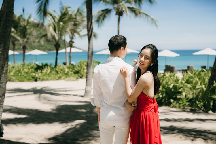 Woman In Dress Posing Near Man In Shirt