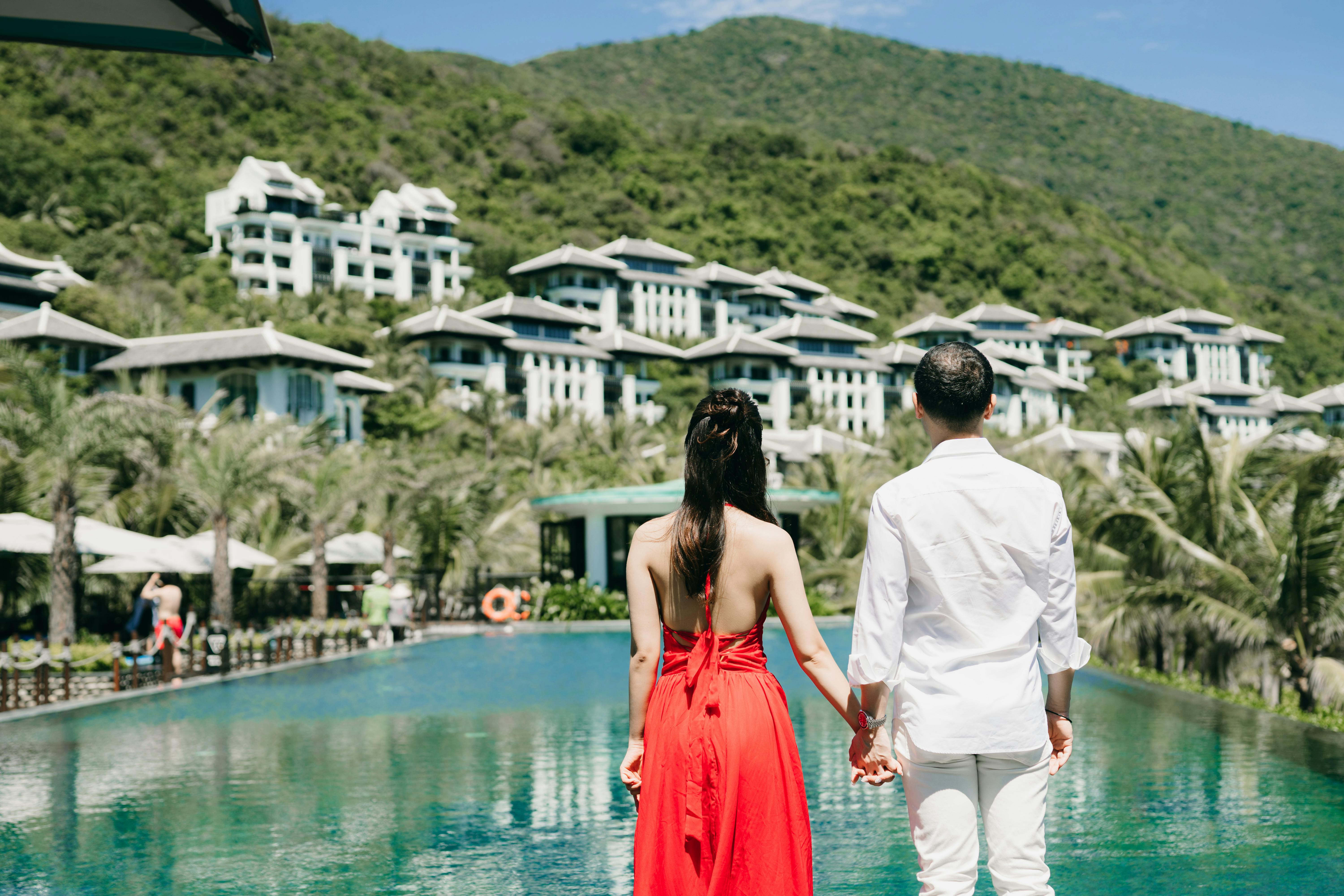 Couple at luxury tropical resort pool