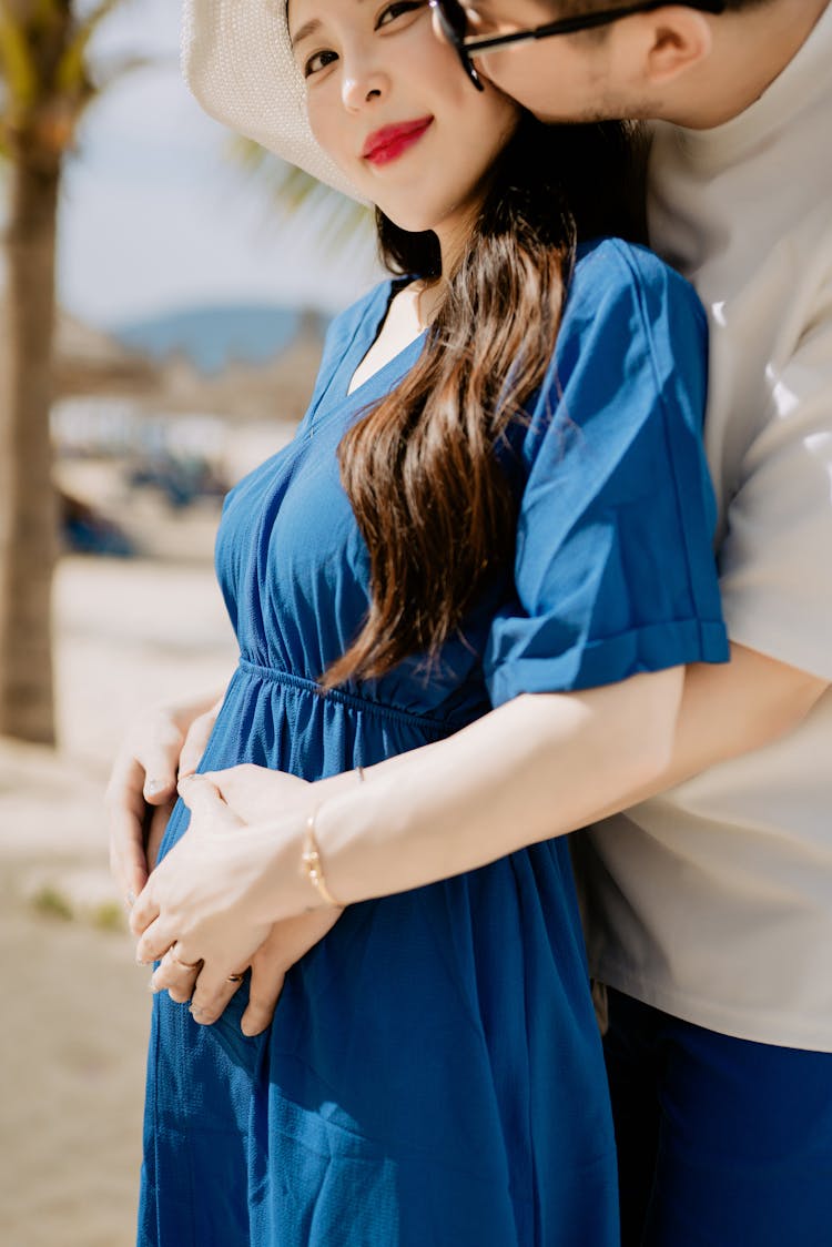 Man Holding His Partners Pregnant Belly 