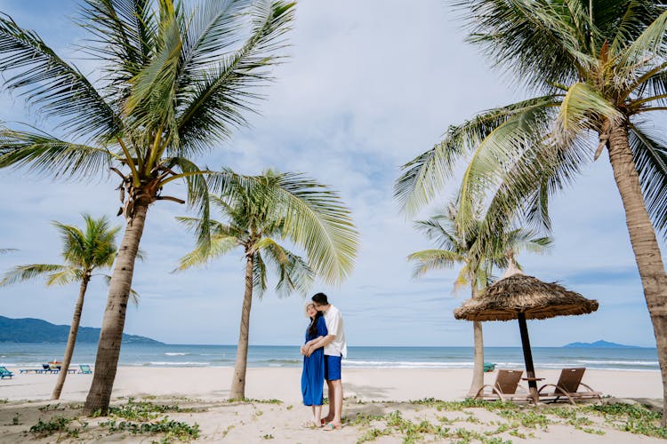 Man And Woman Embracing On Beach