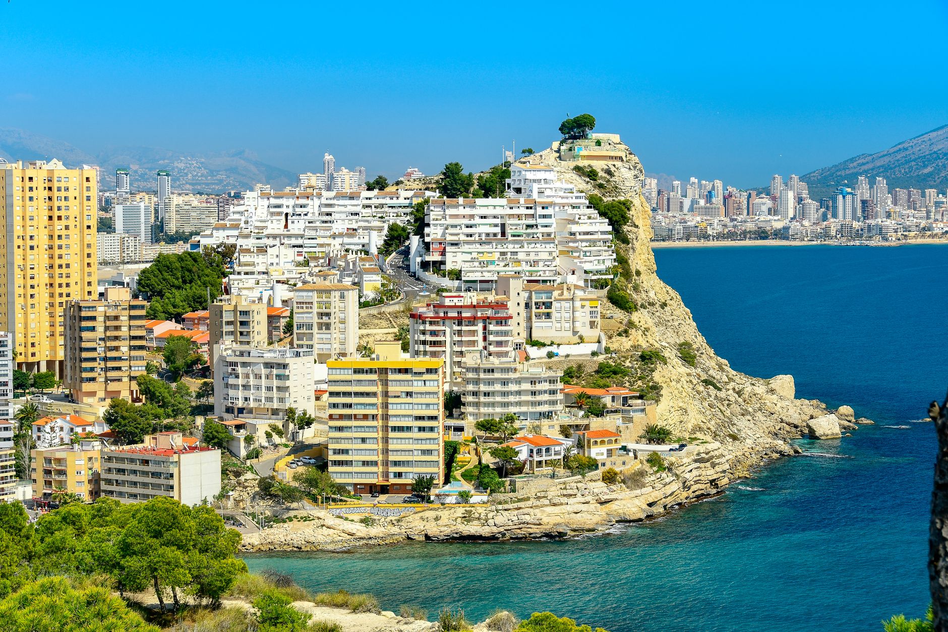 Stunning coastal view of Finestrat, Spain with urban architecture and the Mediterranean Sea.