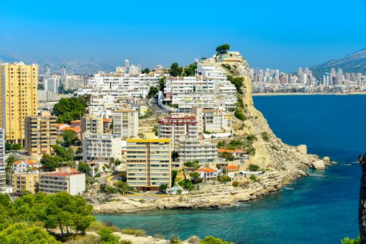 Stunning coastal view of Finestrat, Spain with urban architecture and the Mediterranean Sea.