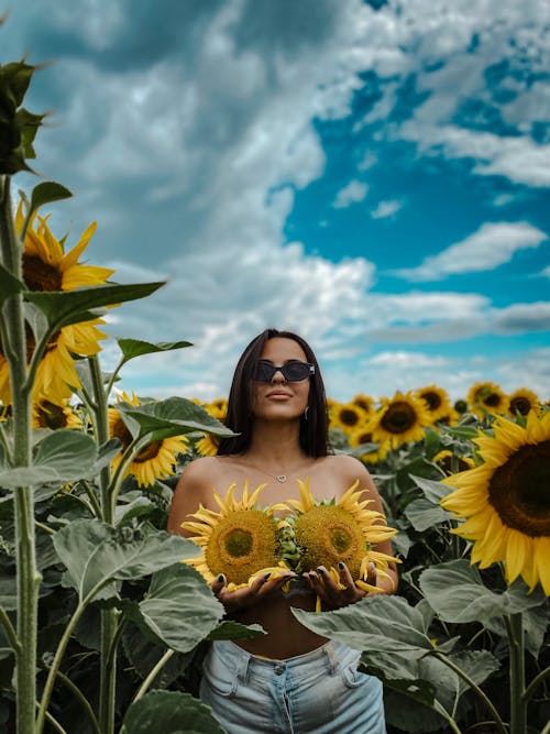 Free A Woman Holding Yellow Flowers Stock Photo