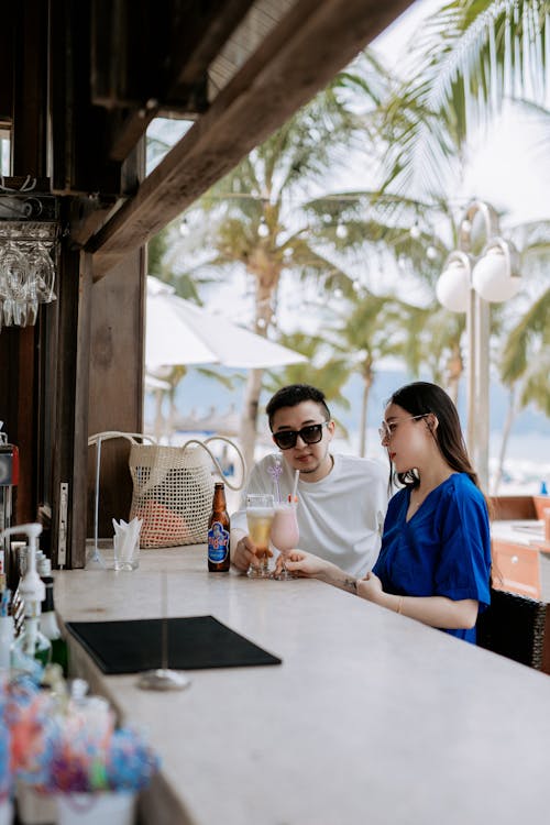 A Couple Having Drinks in a Beach Bar