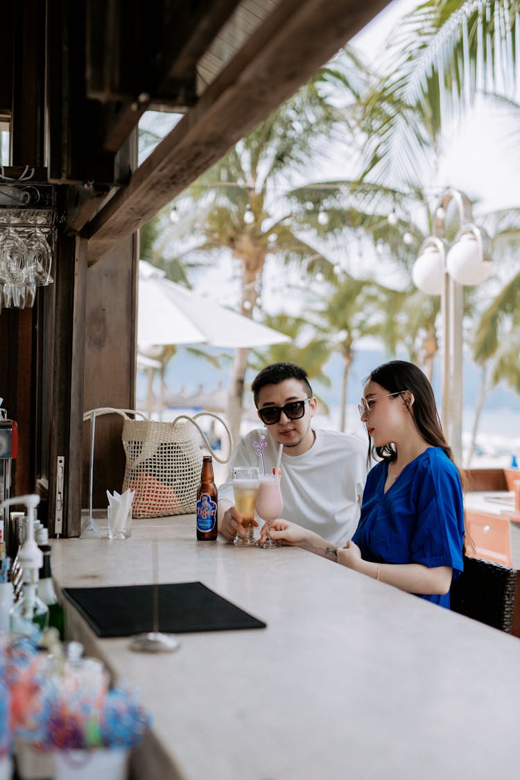 A Couple Having Drinks In A Beach Bar