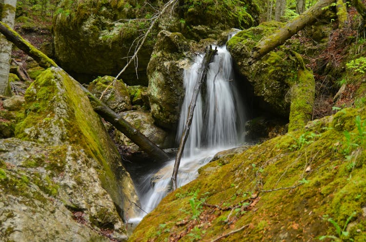 Waterfall Among Rocks In Moss